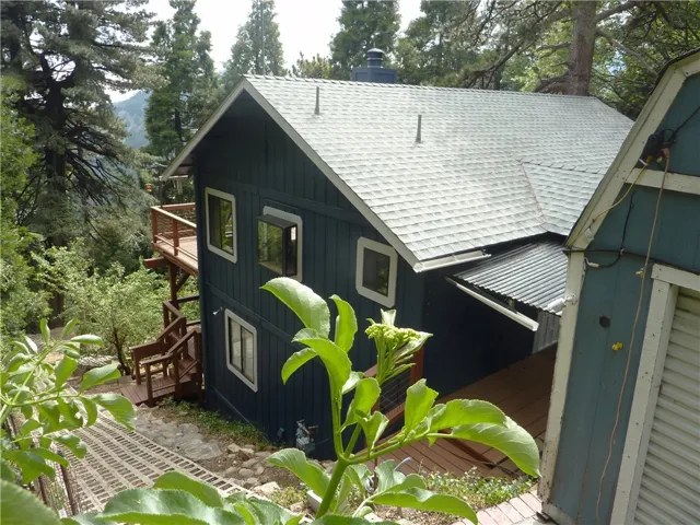 On the east side of the home is the walkway that goes all the way down to the level area behind the home.