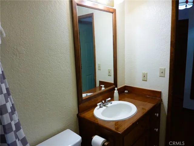 Nice wood counter top around the sink in the main level full bathroom.
