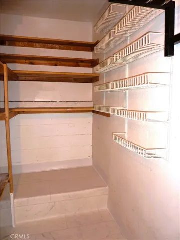 Extra storage in the laundry room opposite the washer dryer.