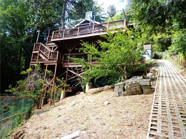 The rear of the home looking up from near the bottom of the walkway to the back yard. Just to the left of the walkway are numerous fruit trees.