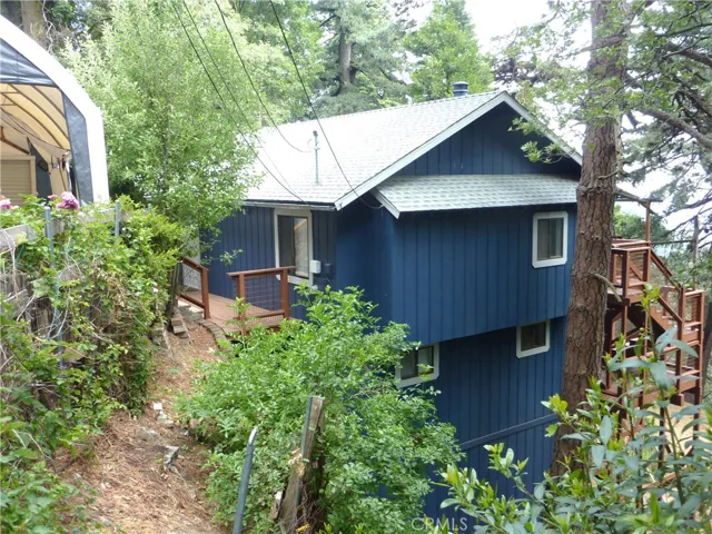 The home is very hard to see from the street. This is the view looking at the west side of the home
