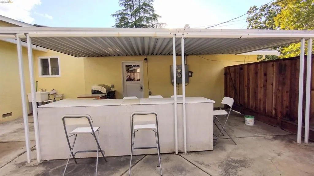 View of patio with a grill