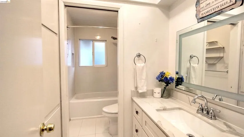 Bathroom featuring vanity, shower / washtub combination, and light tile patterned floors