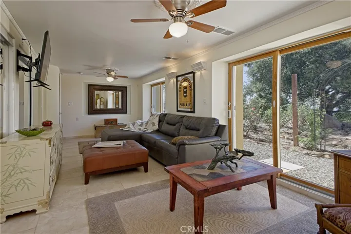 This room is currently the 5th bedroom . it was built with the option to put a wall in the middle to make it 6 bedrooms it has 2 sliders to the outside and 2 closets in the room