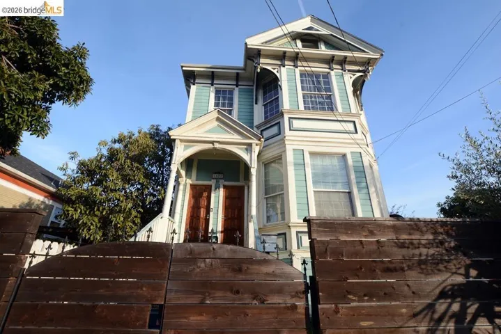 View of front facade with a fenced front yard and a gate
