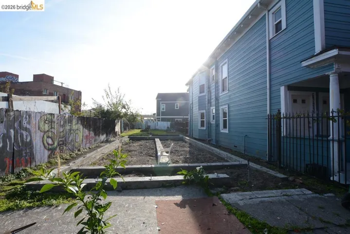 Fenced backyard featuring a garden