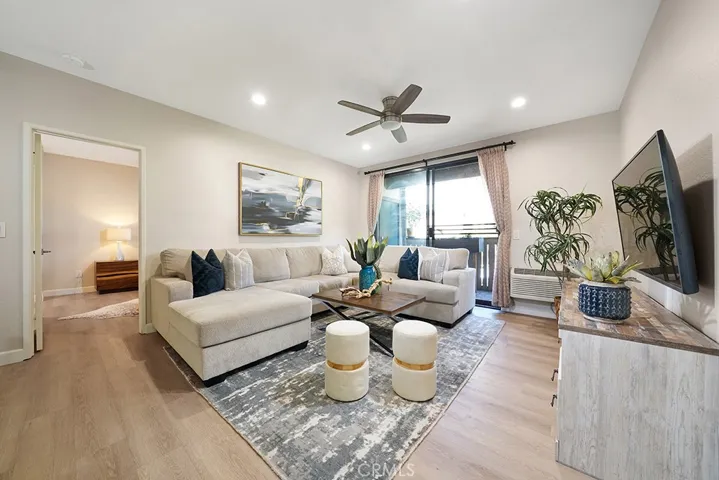 Spacious living area, with ceiling fan, opens to patio
