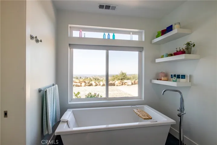 Master bath with freestanding tub and views