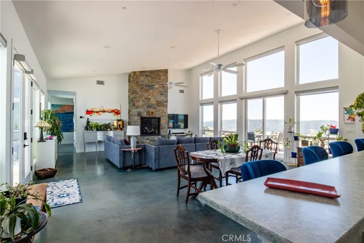 Open living with fireplace and foothill views