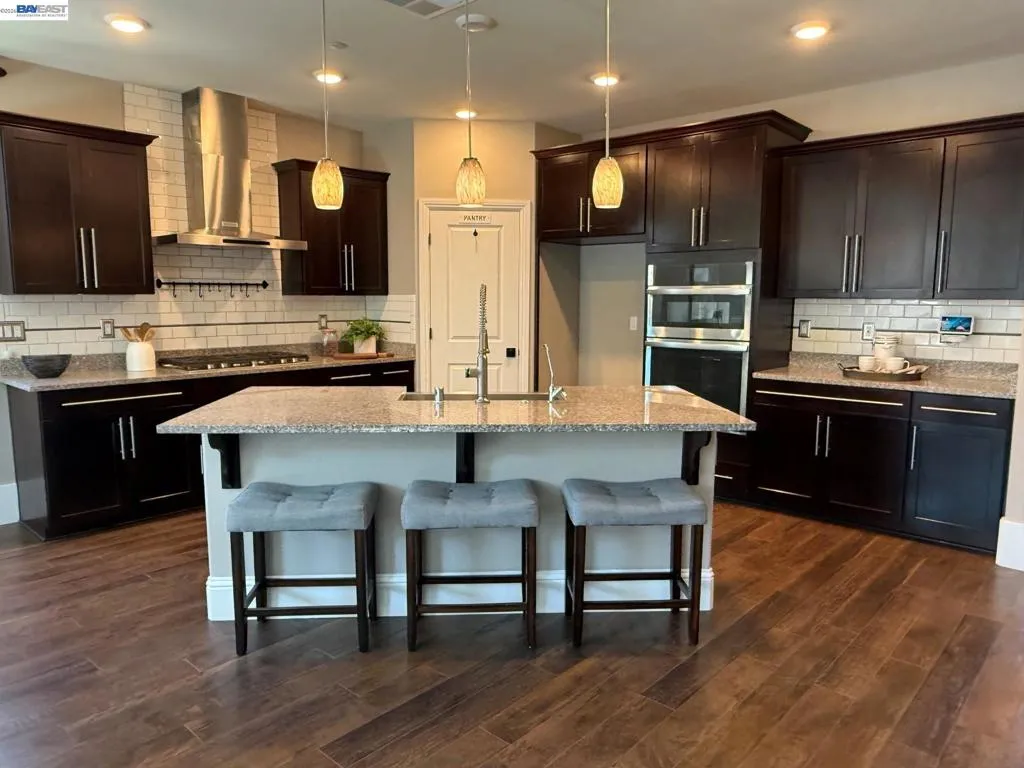 Chef's Kitchen with Cherry Cabinets, granite counters with upgraded tile backsplash. Upgraded SS appliances