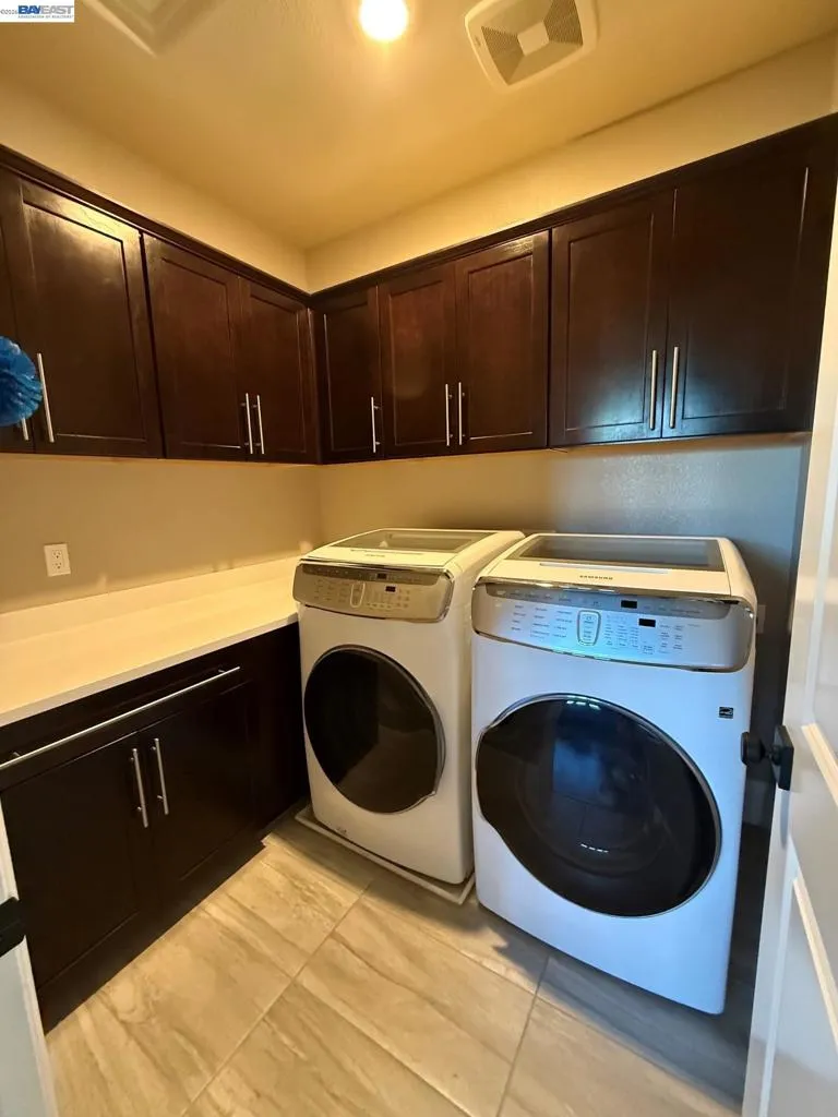Upstairs Laundry with Upscale Waher Dryer and Storage
