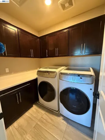 Upstairs Laundry with Upscale Waher Dryer and Storage