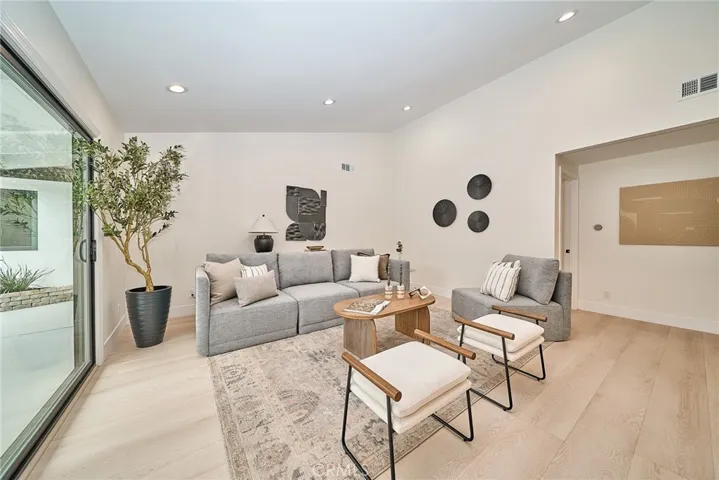SPACIOUS LIVING ROOM WITH VAULTED CEILING AND BACKYARD ACCESS