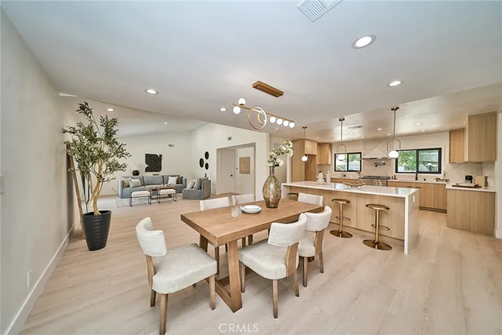 STUNNING OPEN-CONCEPT GREAT ROOM WITH VAULTED CEILINGS AND A DESIGNER CHEF'S KITCHEN FEATURING AN OVERSIZED WATERFALL ISLAND