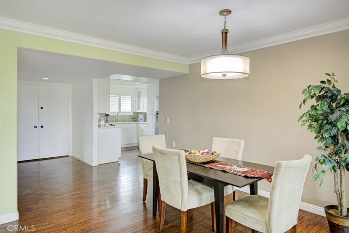 View looking toward the double entry doors and the kitchen.  The dining room easily accommodates seating for 8 and a china cabinet or buffet.
