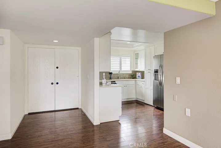 View from the dining room toward the front door and kitchen.