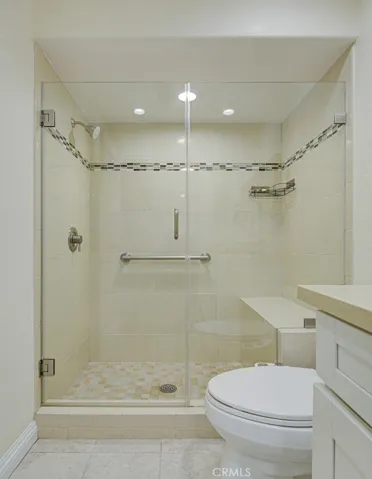 Here's another picture of the step-in shower with bench, grab bars and lighting above the shower (something seldom seen in Laguna Woods.