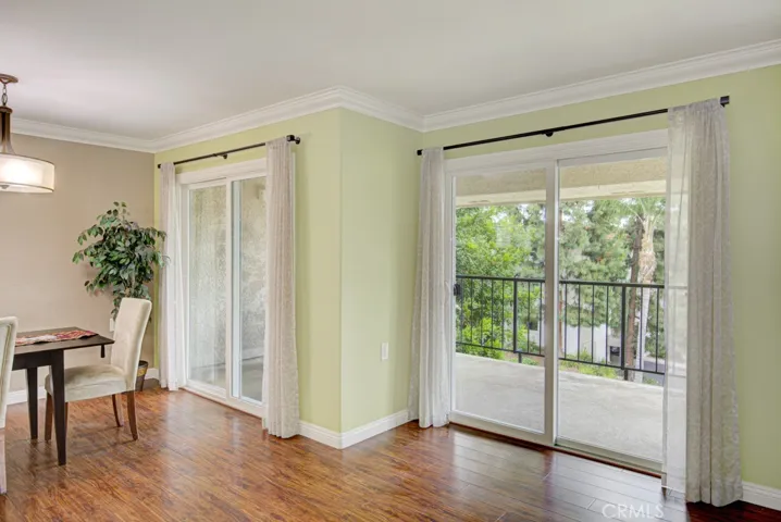 Two large sliding glass doors invite you to step out onto the generous covered patio and enjoy the treetop view.
