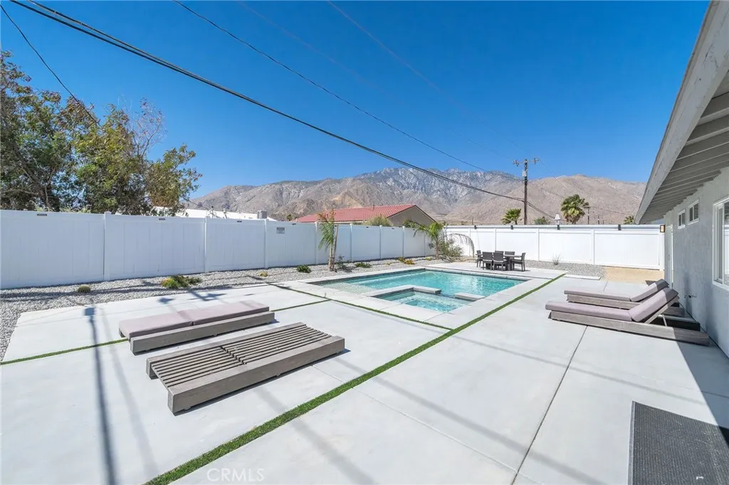 View of San Jacinto mountains in the backyard. Roomy backyard offers plenty of space to entertain or sun yourself. Take a dip in the pool to cool off on the many sunny days. Furniture remains.