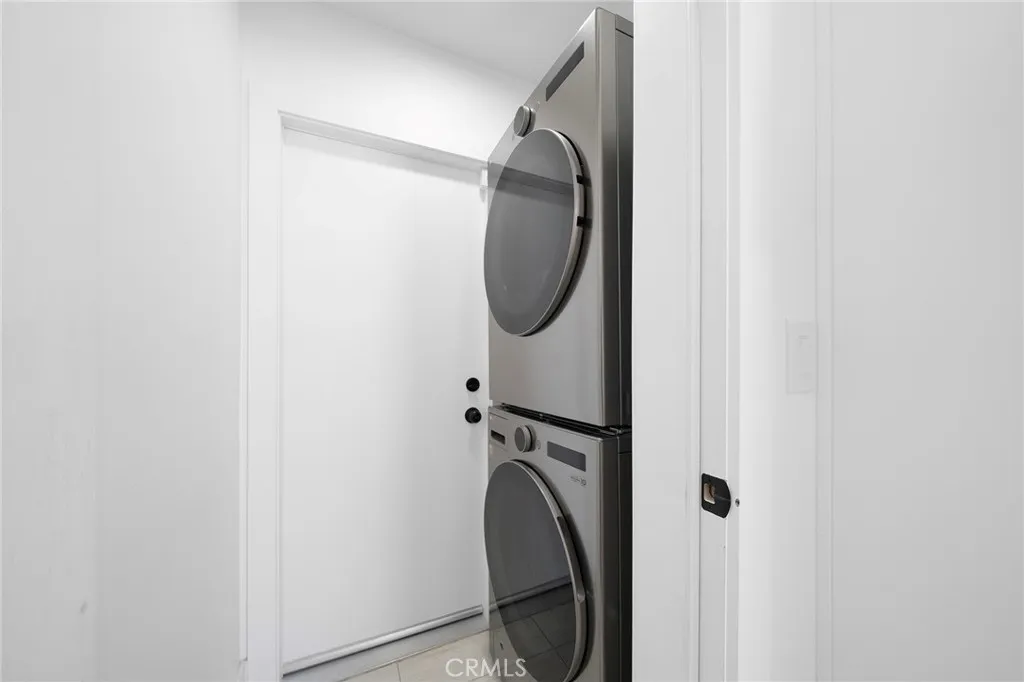 Stackable laundry. Not shown is the garage with epoxy flooring and finished walls that is beyond the door.