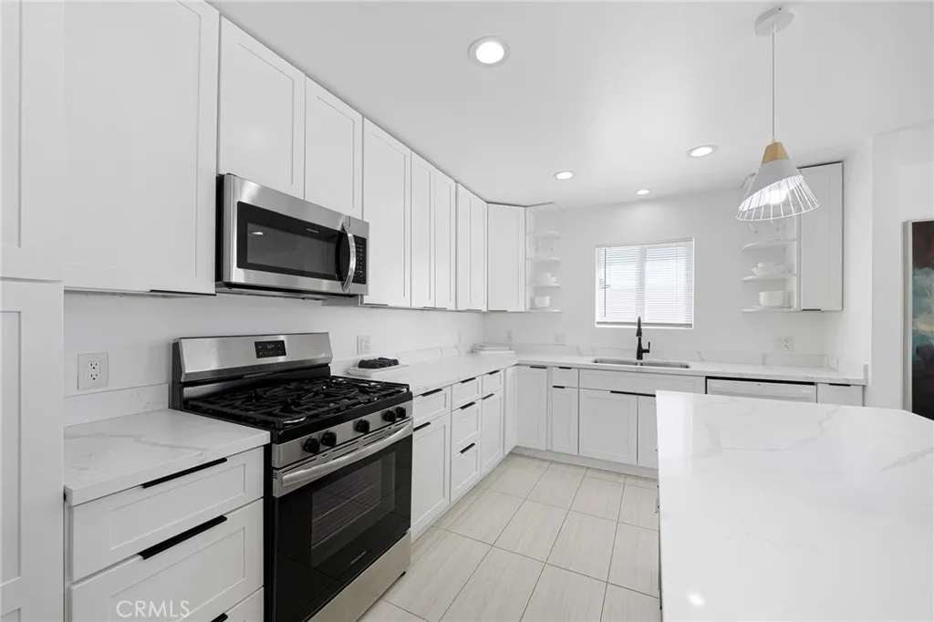 Plenty of counter space to create your masterpiece in the updated kitchen. Appliances remain along with items in cabinets and drawers.