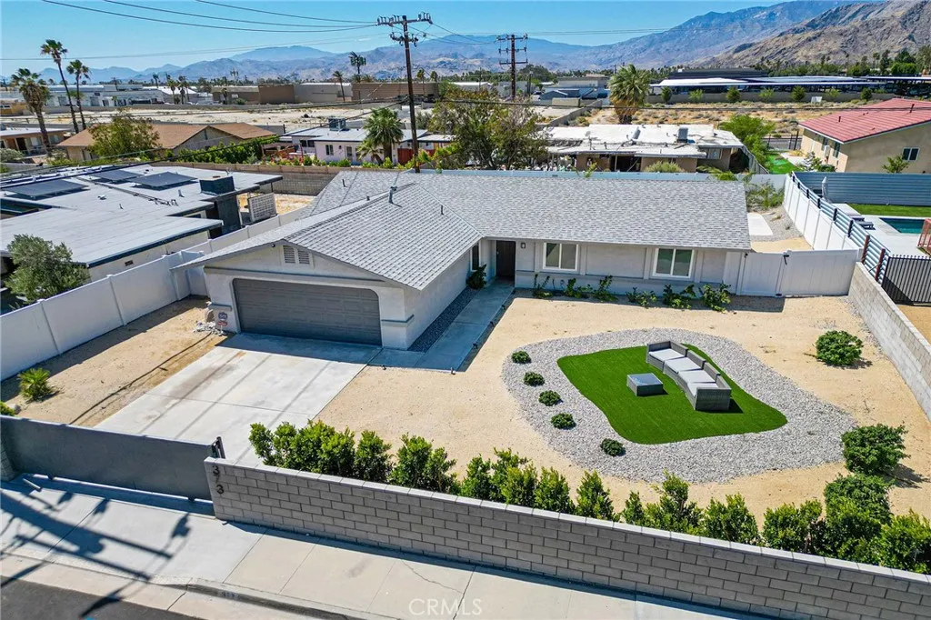 Aerial view of the gated/fenced updated home with pool.