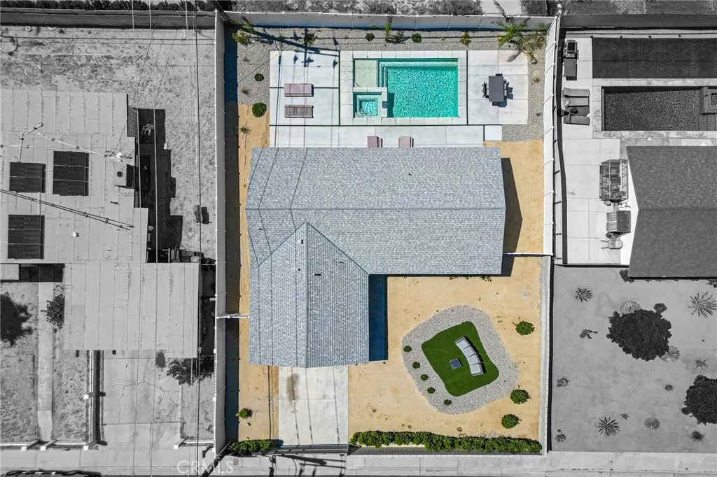 Aerial view of the gated/fenced updated home with pool.