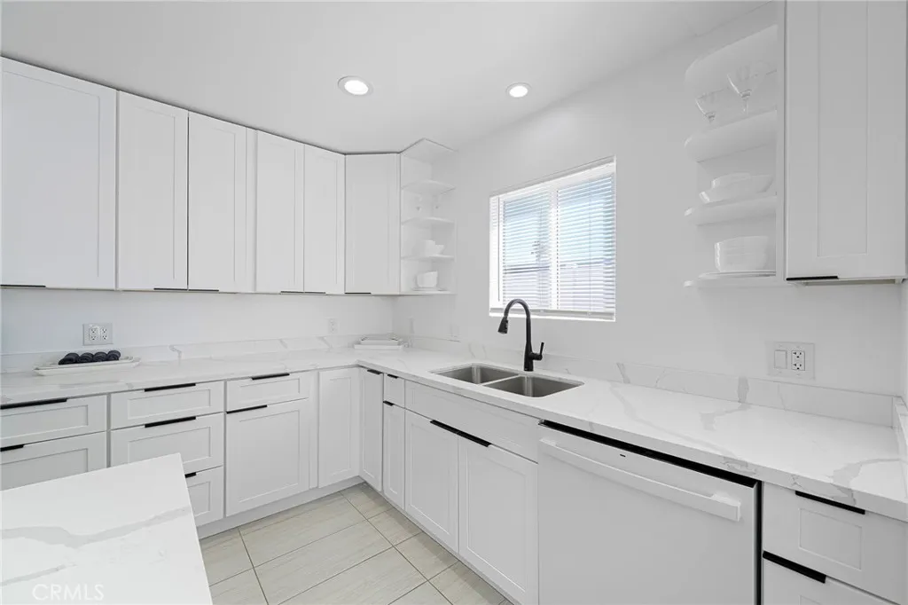 Clean and updated kitchen with appliances to remain and items in cabinets remain as well. Having a clean white palate allows you to bring your color choice of decor and dishes as desired. Window view of spacious side yard.