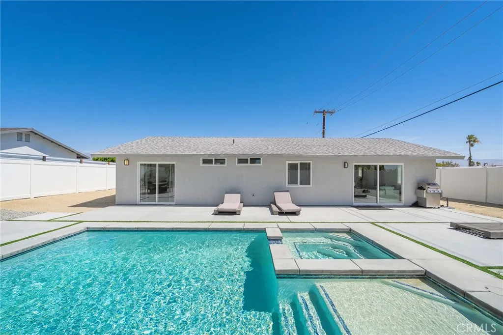 Sparkling pool with Baja shelf and hot tub.