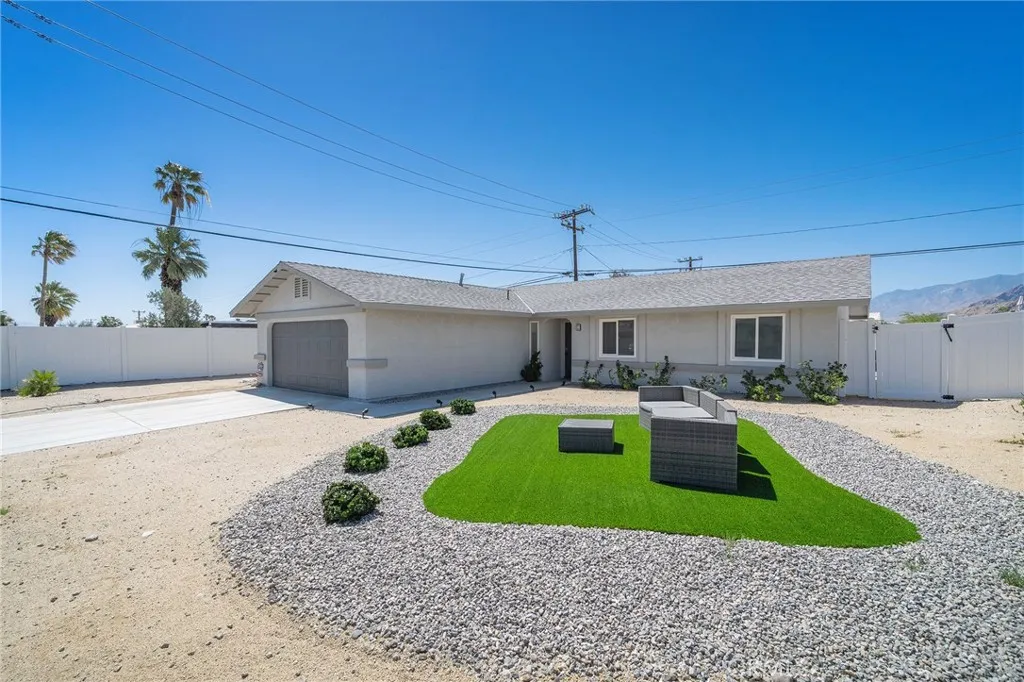 Easy landscaping with turf and rocks. Furniture remains.