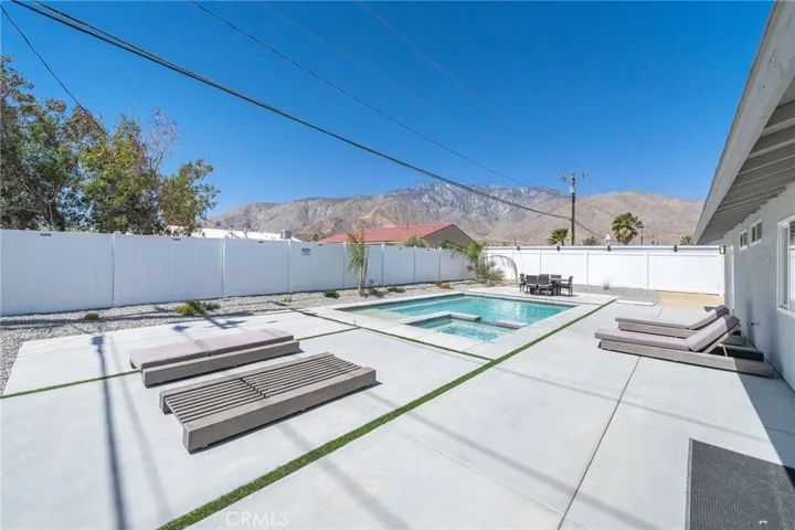 View of San Jacinto mountains in the backyard. Roomy backyard offers plenty of space to entertain or sun yourself. Take a dip in the pool to cool off on the many sunny days. Furniture remains.