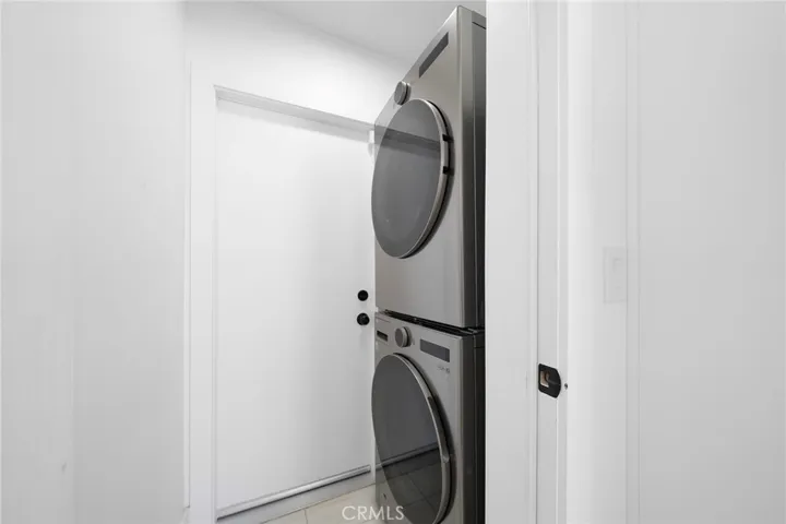 Stackable laundry. Not shown is the garage with epoxy flooring and finished walls that is beyond the door.