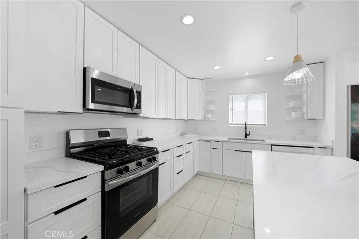 Plenty of counter space to create your masterpiece in the updated kitchen. Appliances remain along with items in cabinets and drawers.