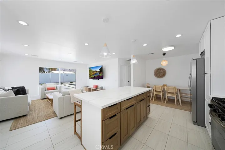 Two toned island cabinet brings earthy tones and offers a classic warm design. Dining area in the distance on the right side. Recessed lighting although, the home has a lot of natural light without the need of turning the lights​​‌​​​​‌​​‌‌​​‌​​​‌‌​​​‌​​‌‌​​‌‌​​‌‌​​​​ on.