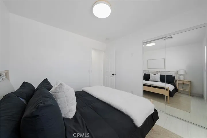 This bedroom is first one on the right going down the hallway right from the entry. Tile flooring, double pane window, mirrored closet doors and view of the front yard. Furniture remains.