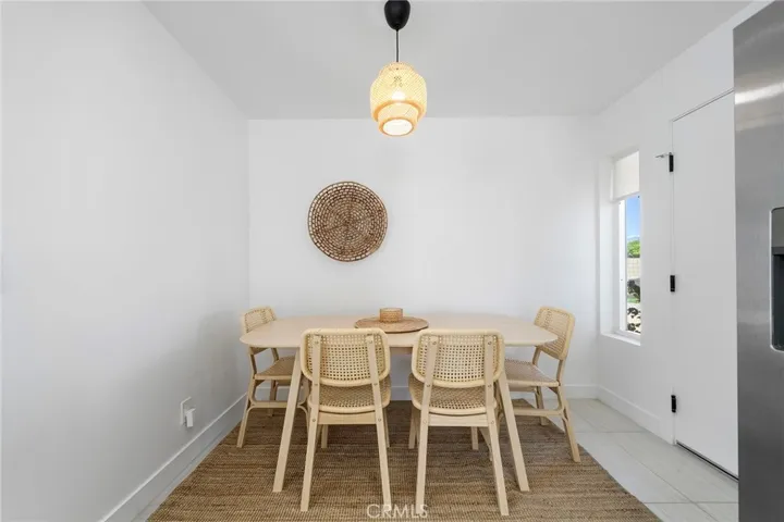 Dining area can accommodate 6. View from window overlooks the front yard. The door to the right leads to the stackable laundry and then a door to the garage.