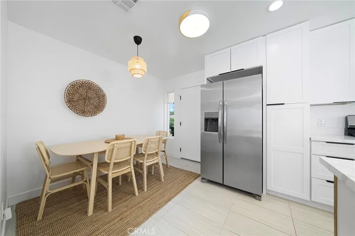 Dining area can accommodate 6. View from window overlooks the front yard. The door to the right leads to the stackable laundry and then a door to the garage.