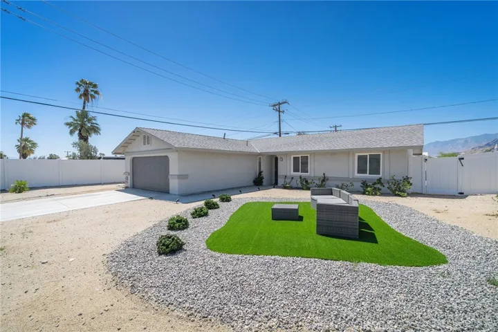 Easy landscaping with turf and rocks. Furniture remains.