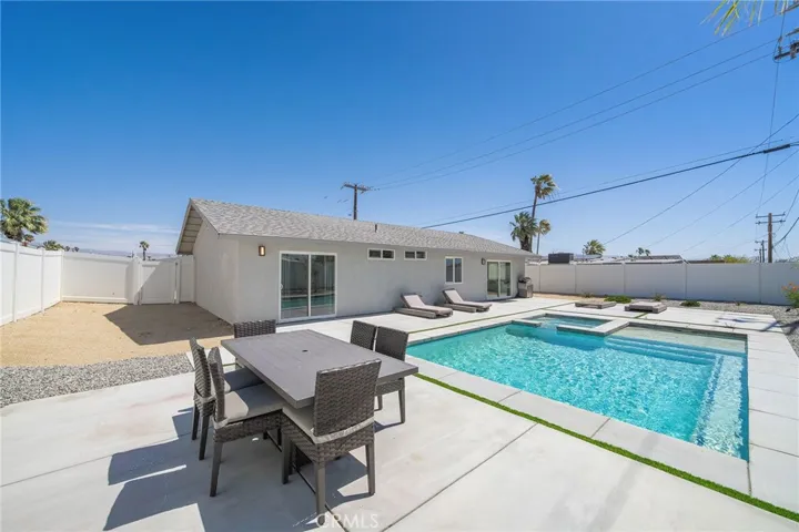 Roomy backyard offers plenty of space to entertain or sun yourself. Take a dip in the pool to cool off on the many sunny days. Furniture remains.