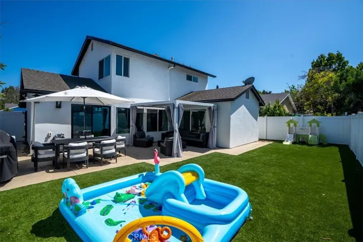 Backyard with small play area, fenced for privacy