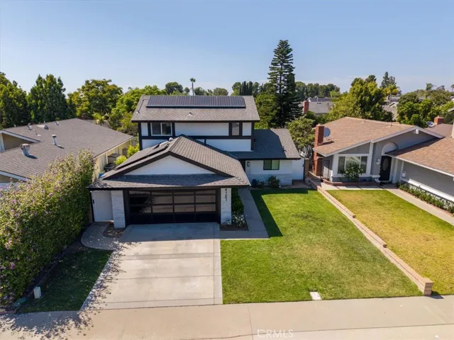 Front exterior view from street showing two-story home with rare two-car garage and manicured lawn.