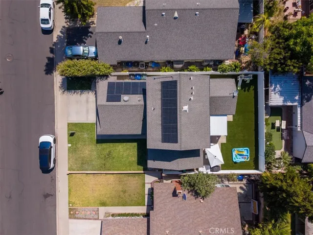 Aerial view of property and surrounding neighborhood highlighting yard and home placement.