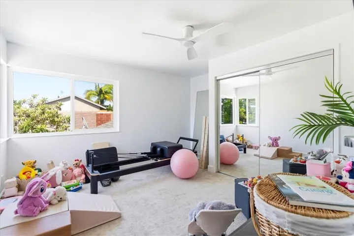 Family or playroom viewed from one angle showing bright interior and large window overlooking backyard.