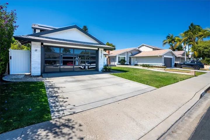 Front exterior shot from the right-angle perspective showing the two-story home, two-car garage, and well-maintained driveway and lawn.