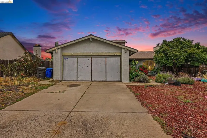 Single-story residence featuring a concrete driveway, stucco exterior, and a two-car garage