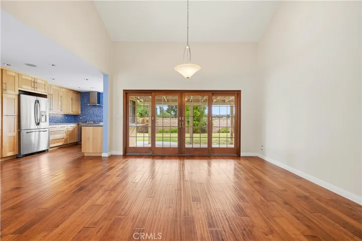 Kitchen and Dinning area with direct access via solid wood French Doors to coverd patio and back yard.