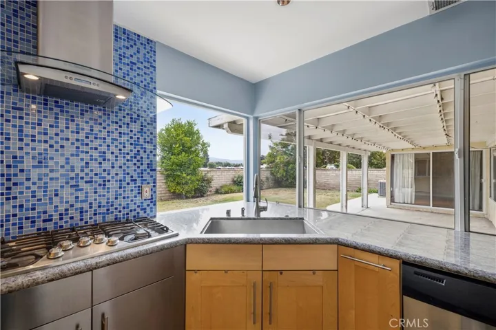corner sink with pass through window and granite that carries through to the exterior patio.