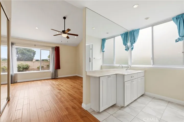 Primary ensuite with valuted ceilings and mirrored wardrobe