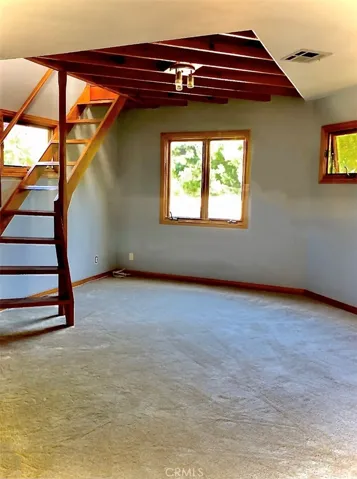 Main living area with stairs to loft