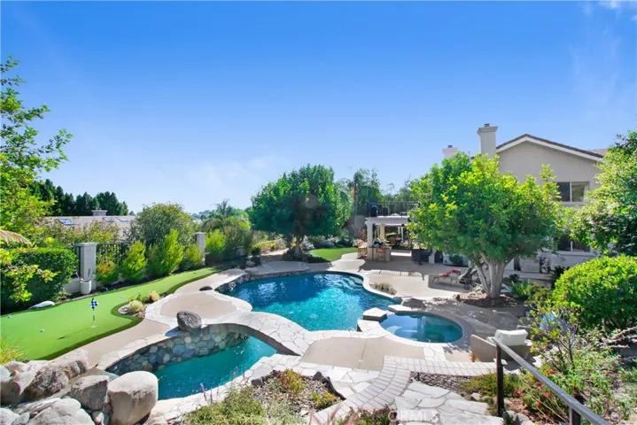 Pebble Tech Pool with Bridge, Waterfall and Solar Heating